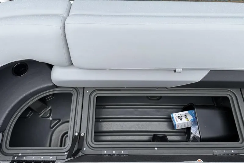 Slide: The Image of 2026 Sun Tracker Party Barge 22 DLX storage compartment with seating and accessories. - 11