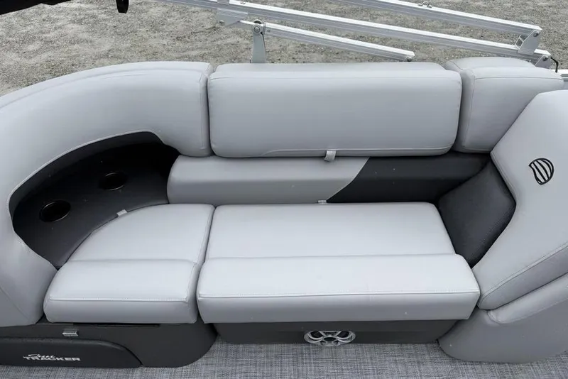 Slide: The Image of 2026 Sun Tracker Party Barge 22 DLX interior with gray cushioned seating and cup holders. - 15