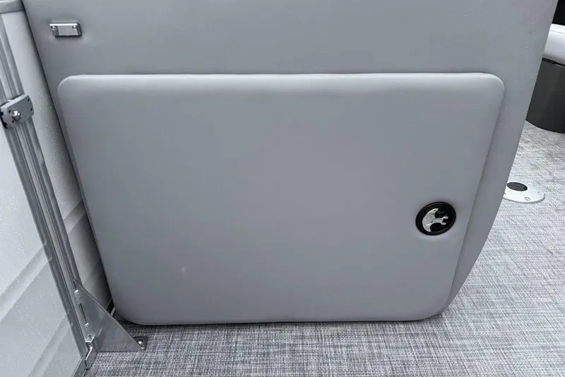 Slide: The Image of 2026 Sun Tracker Party Barge 22 DLX interior detail, featuring a sleek gray panel. - 16