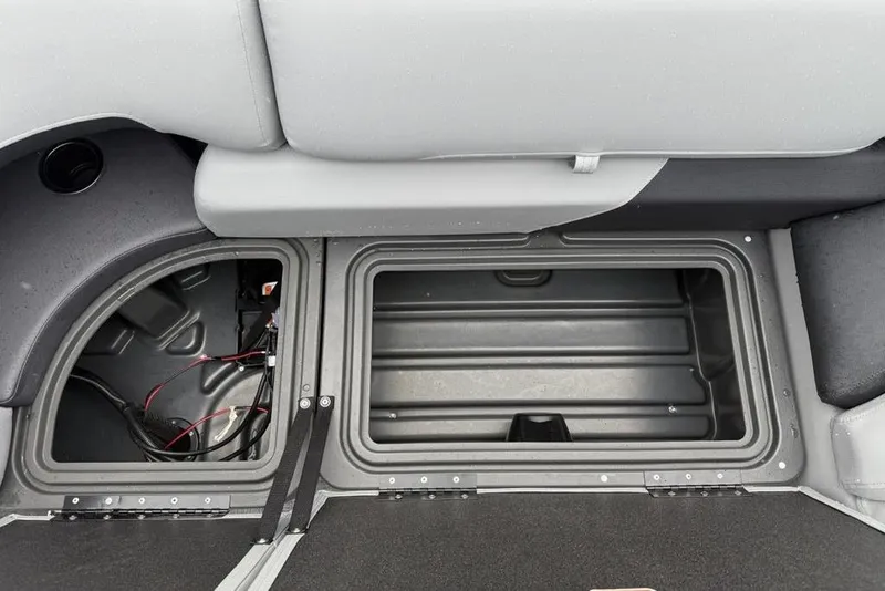 Slide: The Image of 2026 Sun Tracker Party Barge 22 DLX storage compartments with wiring and seating. - 18