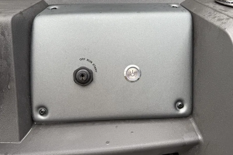 Slide: The Image of Control panel of 2026 Sun Tracker Party Barge 22 DLX with ignition and power button. - 19