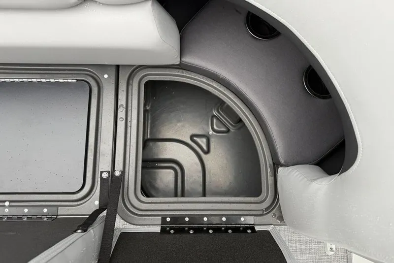 Slide: The Image of 2026 Sun Tracker Party Barge 22 DLX storage compartment with cushioned seating. - 23