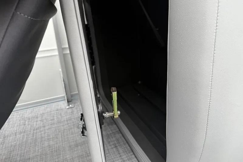 Slide: The Image of 2026 Sun Tracker Party Barge 22 DLX interior detail with seat hinge mechanism. - 24