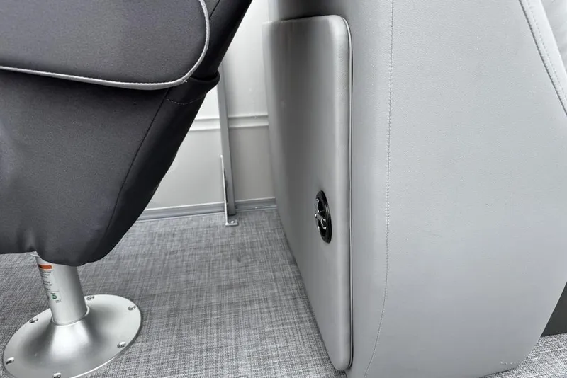 Slide: The Image of 2026 Sun Tracker Party Barge 22 DLX interior seating detail with gray upholstery. - 27