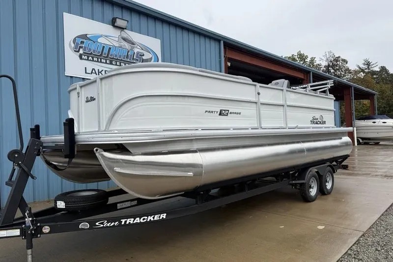 Slide: The Image of 2026 Sun Tracker Party Barge 22 DLX pontoon boat on trailer at Foothills Marine Center. - 6
