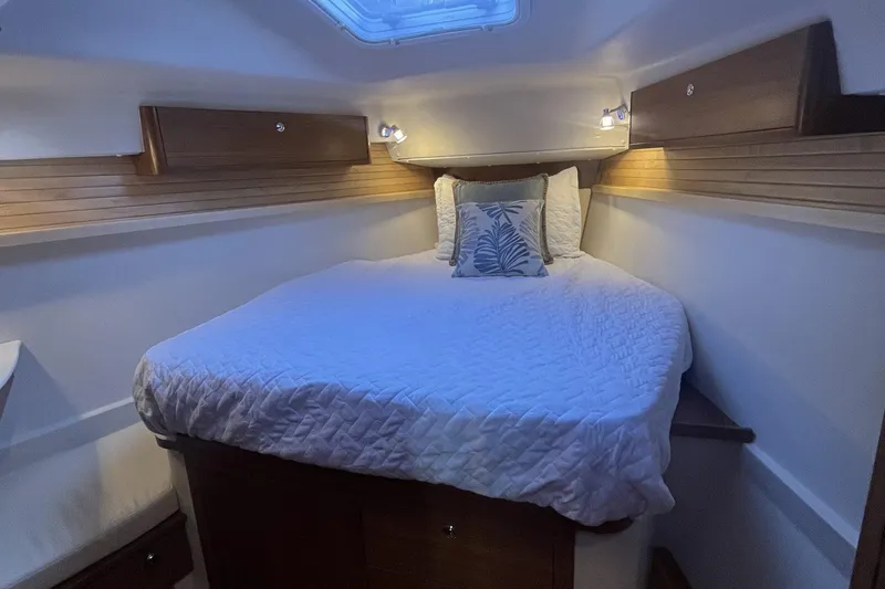 Slide: The Image of Cozy cabin interior of 2026 Catalina 386 sailboat with comfortable bedding and ambient lighting. - 10