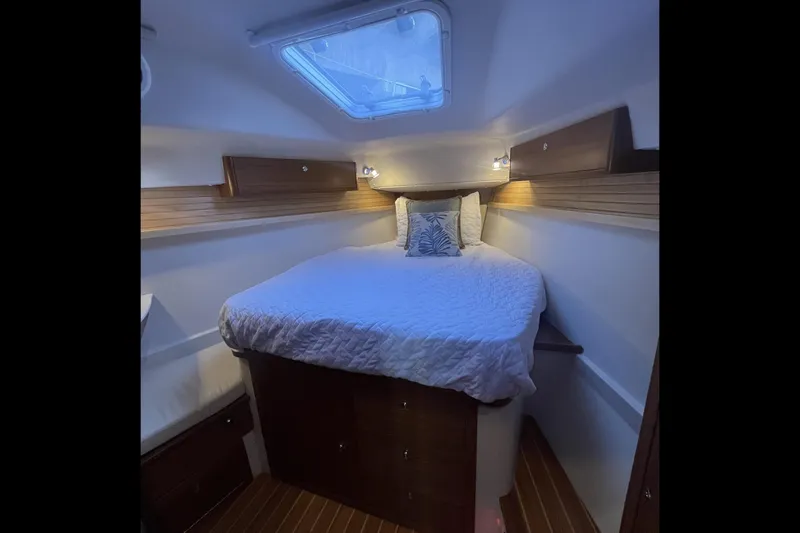 Slide: The Image of Cozy cabin interior of 2026 Catalina 386 sailboat with skylight and wooden accents. - 11