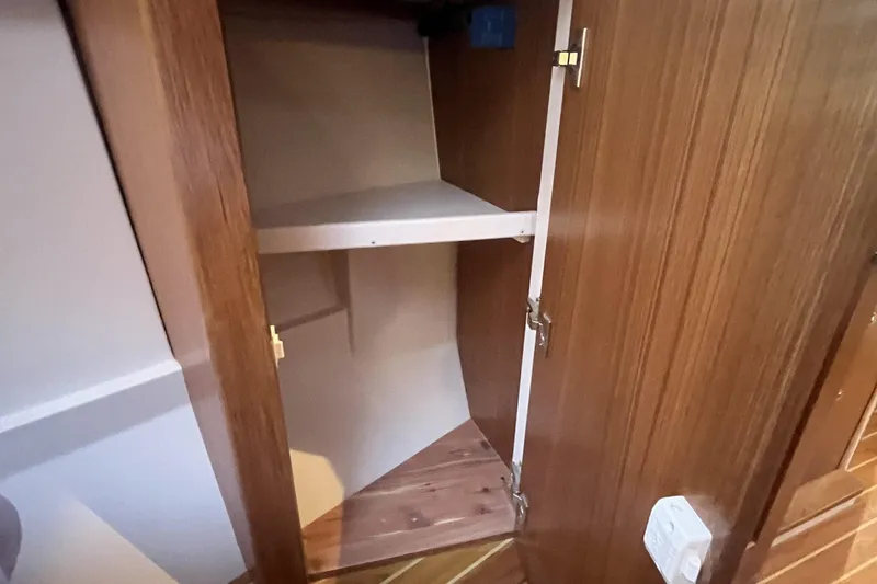 Slide: The Image of Wooden cabinet interior with shelves in a 2026 Catalina 386 model. - 15