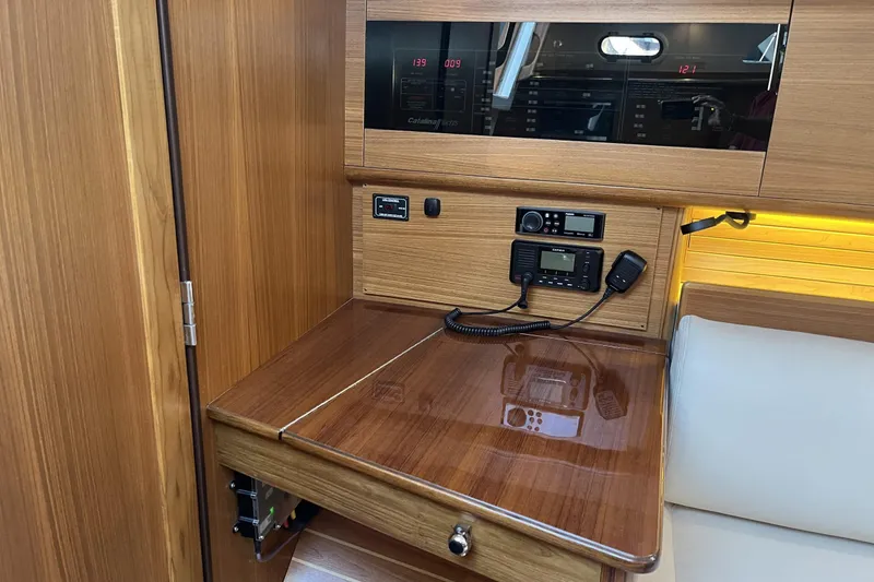 Slide: The Image of Navigation station in 2026 Catalina 386 yacht with wood finish and communication equipment. - 18