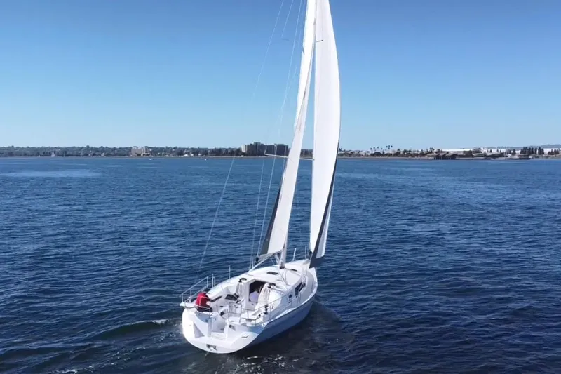 Slide: The Image of Sailing yacht Catalina 386, 2026 model, gliding on open water under clear blue skies. - 2