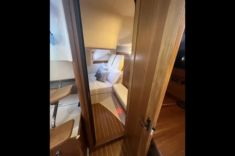 Slide: The Image of Cozy cabin interior of 2026 Catalina 386 sailboat with wooden finishes and comfortable bedding. - 21