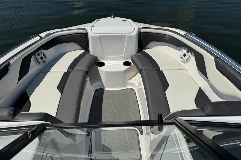 Slide: The Image of 2020 Yamaha AR210 boat interior with cushioned seating and cup holders. - 10