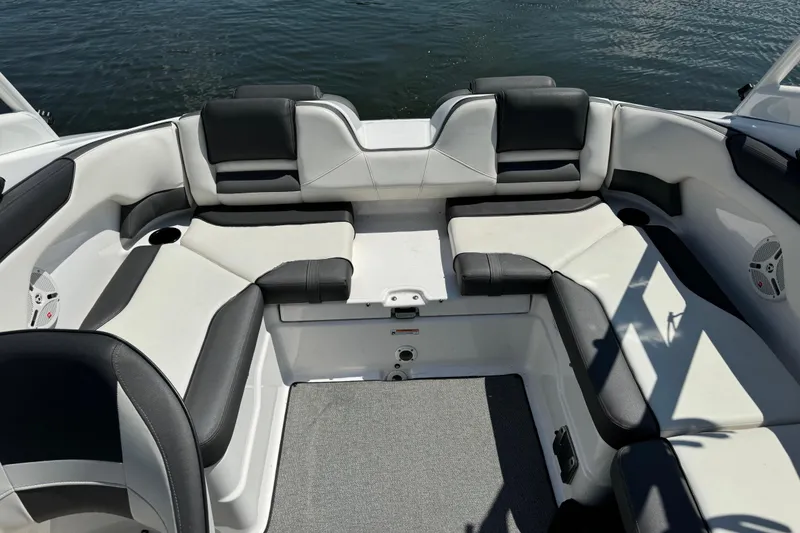 Slide: The Image of 2020 Yamaha AR210 boat interior with cushioned seating and water view. - 11