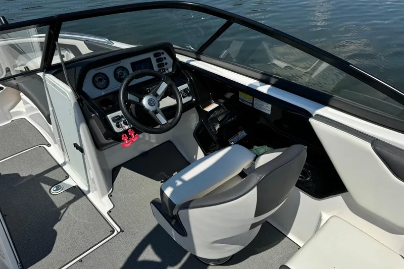 Slide: The Image of 2020 Yamaha AR210 boat cockpit with steering wheel and dashboard controls. - 12