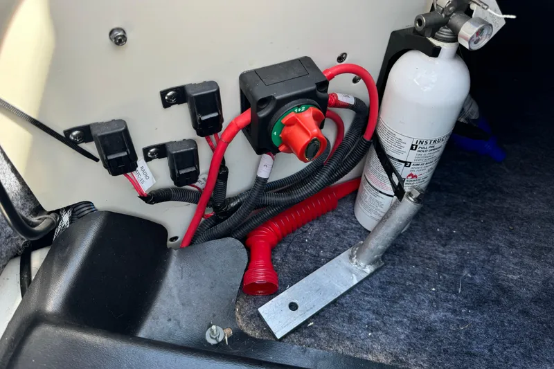 Slide: The Image of Electrical panel and fire extinguisher in 2020 Yamaha AR210 boat interior. - 18