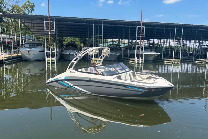 Slide: The Image of 2020 Yamaha Boats AR210 in marina, surrounded by other boats under a clear blue sky. - 3
