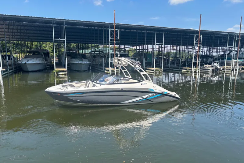Slide: The Image of 2020 Yamaha AR210 boat docked in marina under clear blue sky. - 4