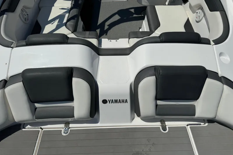 Slide: The Image of 2020 Yamaha Boats AR210 interior seating with black and white upholstery. - 8