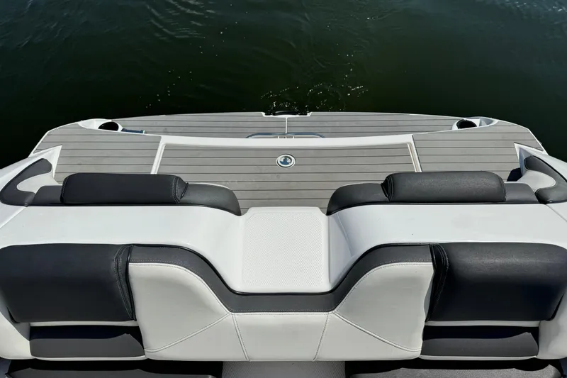 Slide: The Image of 2020 Yamaha AR210 boat with sleek seating and swim platform on calm water. - 9