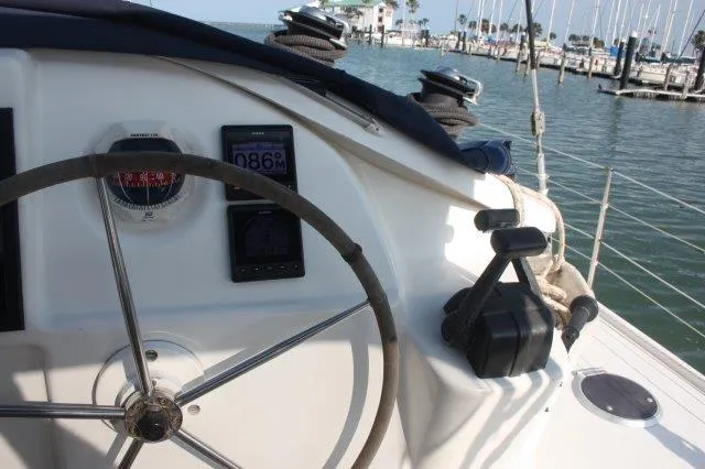Slide: The Image of 2008 Fountaine Pajot Orana 44 yacht helm with navigation instruments in a marina. - 13