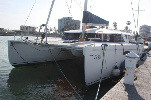 Slide: The Image of 2008 Fountaine Pajot Orana 44 catamaran docked at a marina. - 2