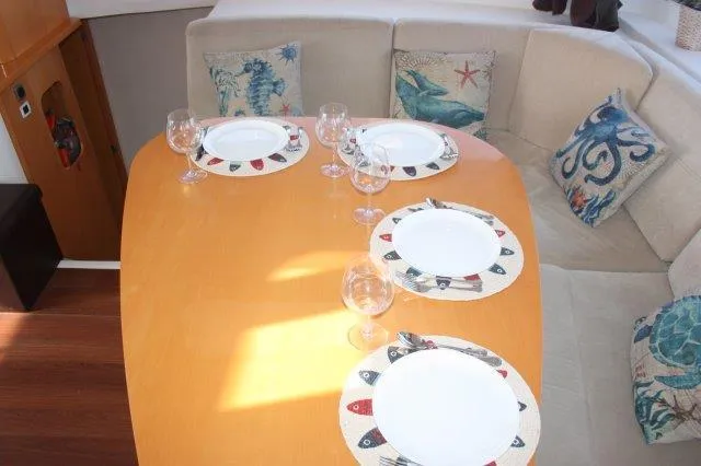 Slide: The Image of Dining area of 2008 Fountaine Pajot Orana 44 catamaran with set table and nautical-themed cushions. - 25