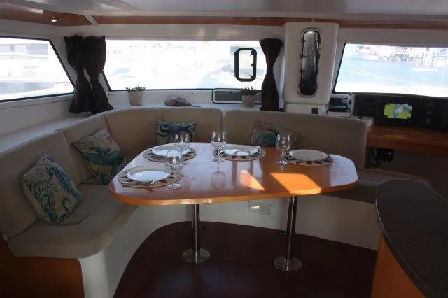 Slide: The Image of Interior dining area of 2008 Fountaine Pajot Orana 44 catamaran with set table. - 26