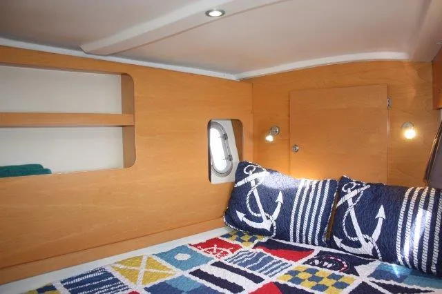 Slide: The Image of Cozy cabin interior of 2008 Fountaine Pajot Orana 44 with nautical-themed bedding. - 32