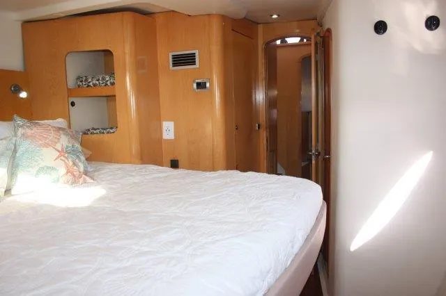 Slide: The Image of 2008 Fountaine Pajot Orana 44 catamaran bedroom with wooden cabinetry and white bedding. - 39