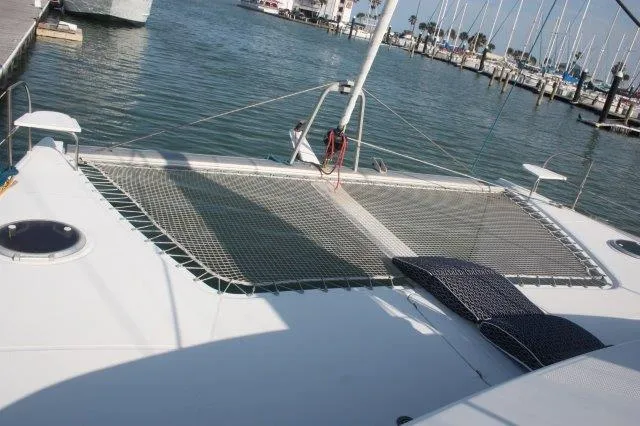Slide: The Image of 2008 Fountaine Pajot Orana 44 catamaran at marina, featuring spacious deck and netting. - 5