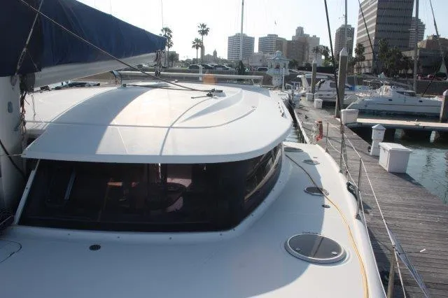 Slide: The Image of 2008 Fountaine Pajot Orana 44 catamaran docked at a marina. - 6