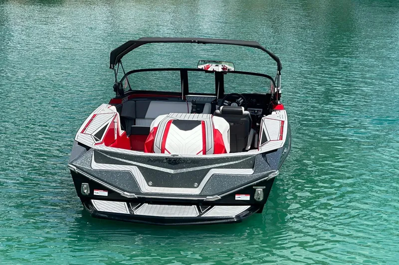 Slide: The Image of 2025 Nautique Ski Nautique boat on clear water, showcasing sleek design and vibrant colors. - 12