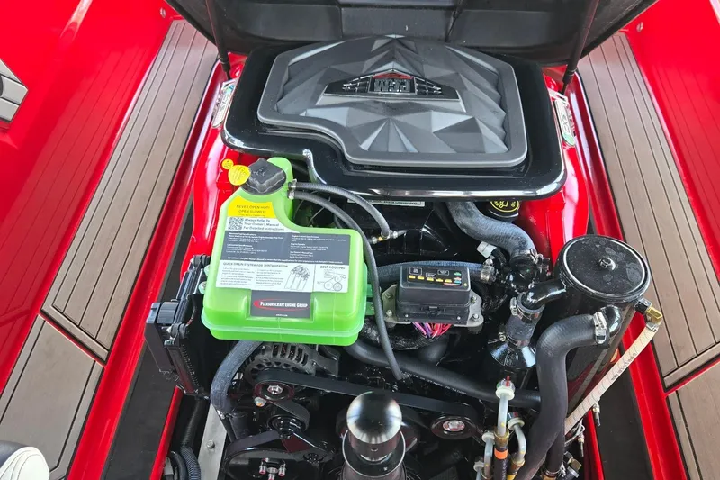 Slide: The Image of 2025 Nautique Ski Nautique engine compartment with detailed components and vibrant red accents. - 9
