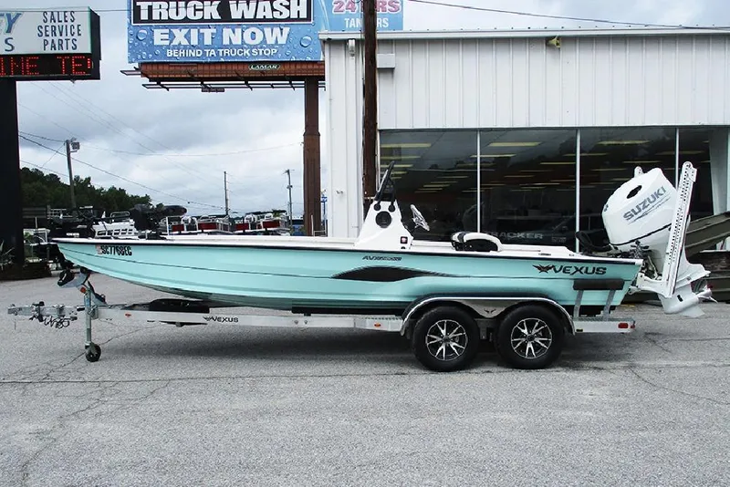 The Image of 2023 Vexus AVX2180CC boat on trailer, parked outside dealership, featuring Suzuki outboard motor. - 1