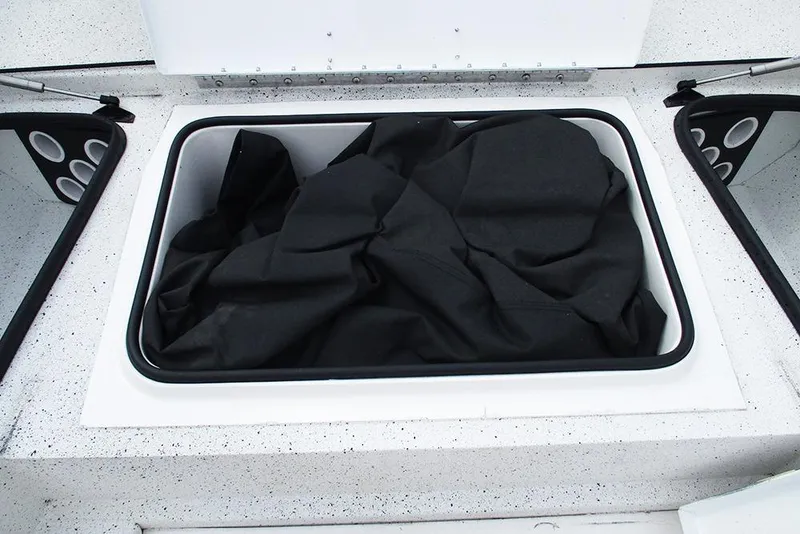 Slide: The Image of Storage compartment of 2023 Vexus AVX2180CC boat with black fabric inside. - 16