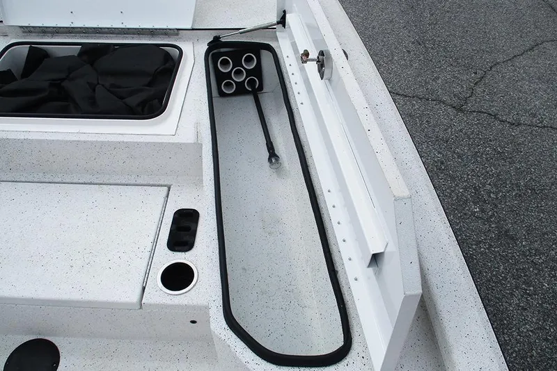 Slide: The Image of 2023 Vexus AVX2180CC boat interior storage compartment with rod holders and cup holder. - 17