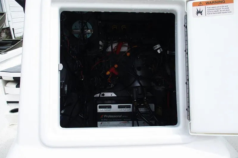 Slide: The Image of 2023 Vexus AVX2180CC boat compartment with wiring and battery setup. - 19