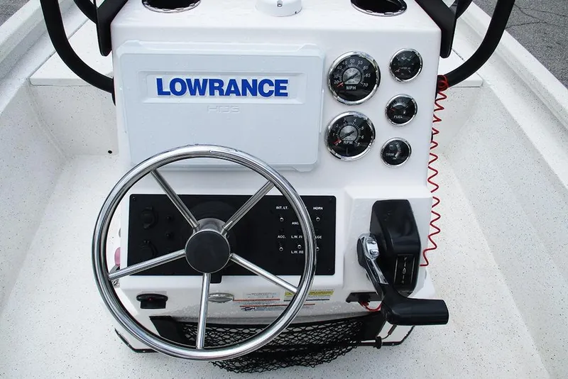 Slide: The Image of 2023 Vexus AVX2180CC boat console with steering wheel, gauges, and Lowrance display. - 29