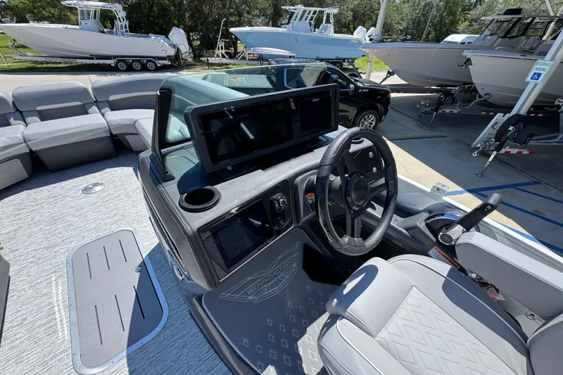 Slide: The Image of 2026 Bennington 24 MSB boat interior with modern helm and seating. - 23
