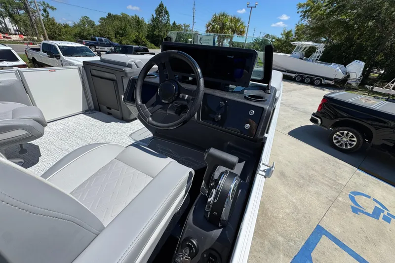 Slide: The Image of 2026 Bennington 24 MSB boat interior with steering wheel and control panel. - 26