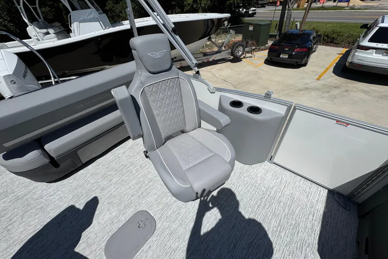 Slide: The Image of 2026 Bennington 24 MSB boat interior with gray captain's chair and cup holders. - 28