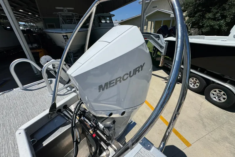 Slide: The Image of Outboard motor on a 2026 Bennington 24 MSB boat, featuring a Mercury engine. - 37