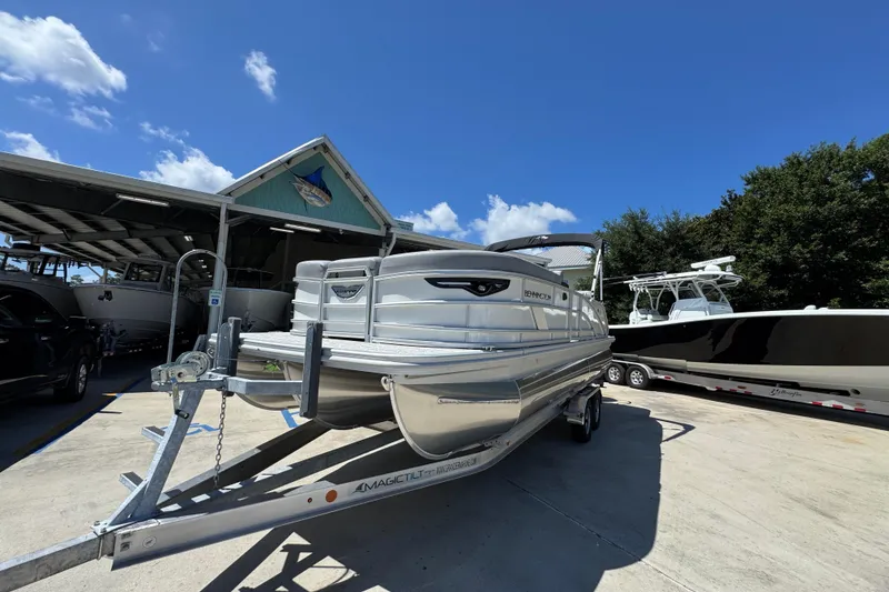 Slide: The Image of 2026 Bennington 24 MSB pontoon boat on trailer under clear blue sky. - 4