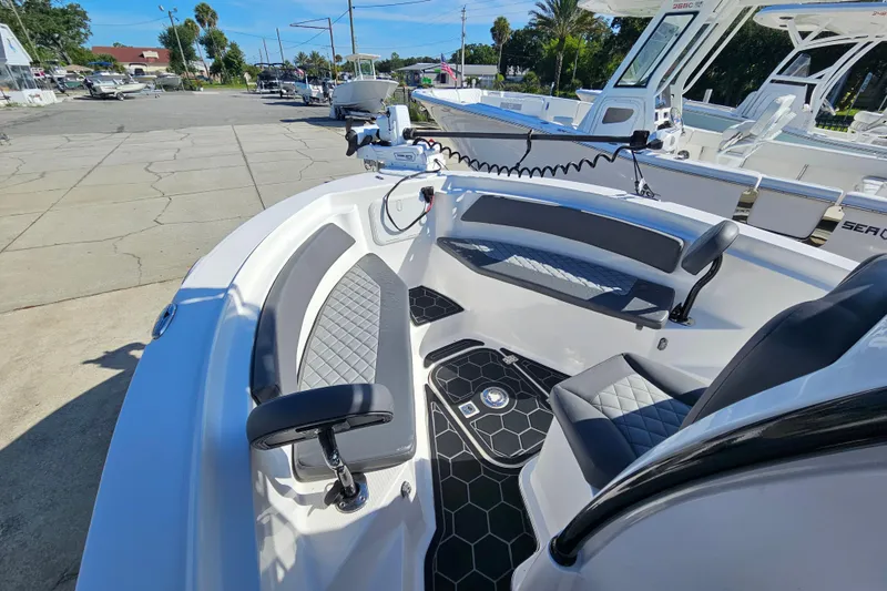 Slide: The Image of 2024 Polar 220CC boat interior with modern seating and steering, docked at a marina. - 3