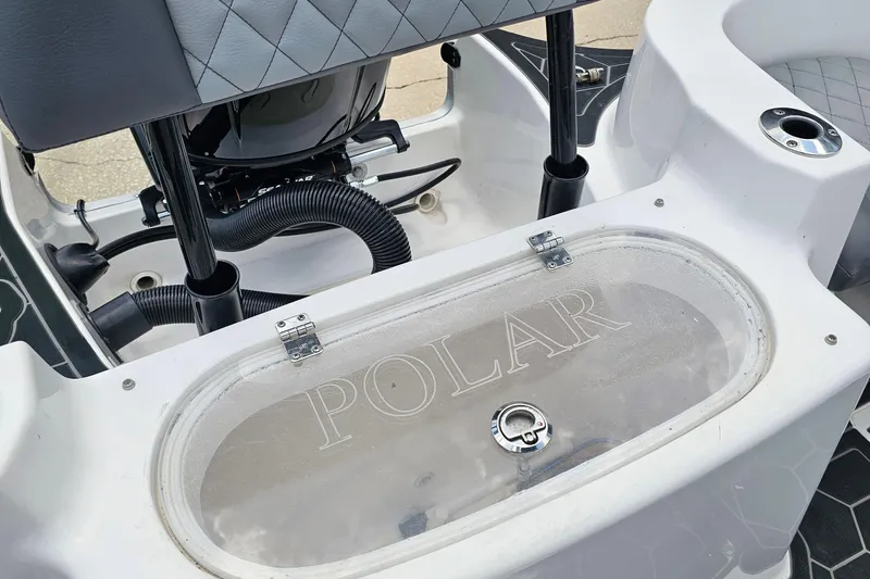 Slide: The Image of 2024 Polar 220CC boat interior with storage compartment and sleek design. - 6