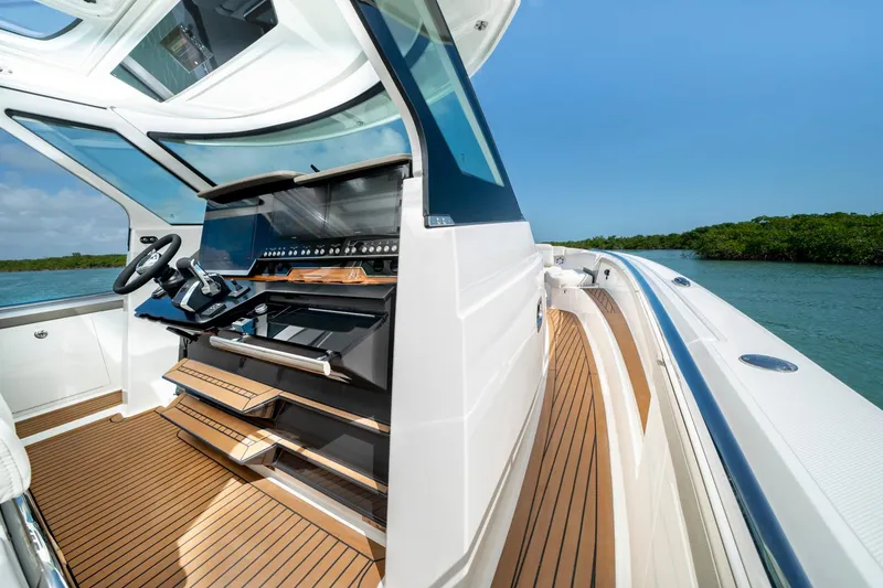 Slide: The Image of Manufacturer Provided Image: 2023 Tiara Yachts 48 LS helm station with teak flooring and modern controls. - 12