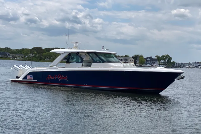 Slide: The Image of 2023 Tiara Yachts 48 LS boat on water, side view, with "Don't Blink" text. - 2