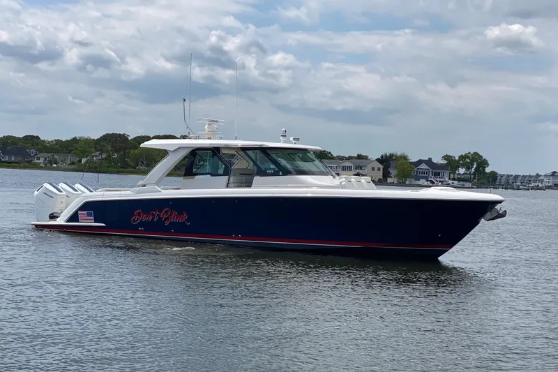 Slide: The Image of 2023 Tiara Yachts 48 LS boat on calm water, side view. - 24