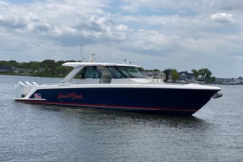 Slide: The Image of 2023 Tiara Yachts 48 LS boat on water, sleek design, overcast sky. - 25