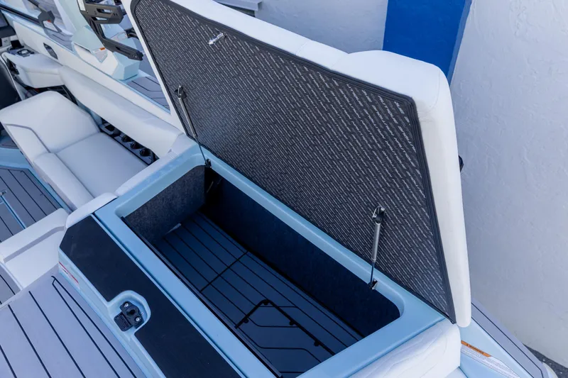 Slide: The Image of 2026 Nautique Super Air Nautique G23 boat storage compartment open, showcasing interior design. - 10